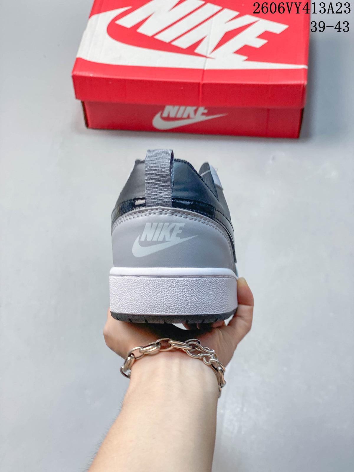 Rear view of a gray NikeCourt Borough 2 sneaker with a white midsole