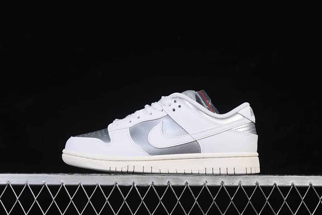 Side view of a white and silver Nike SB Dunk Low sneaker