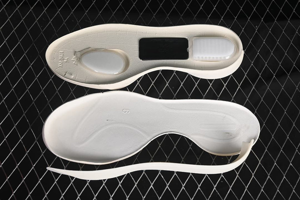 Two views of the shoe insole and outsole components
