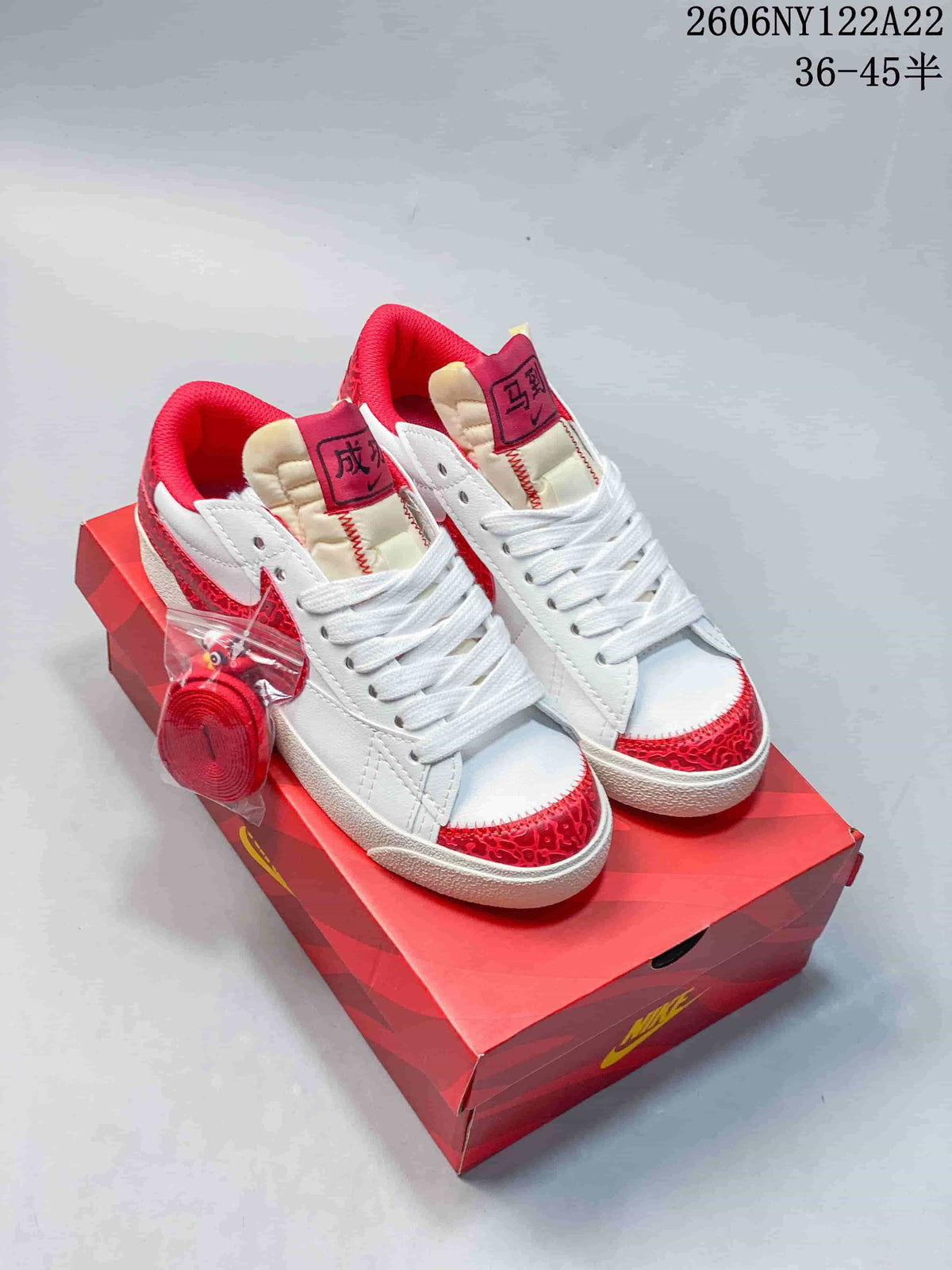 White sneakers with red patterned accents and white laces