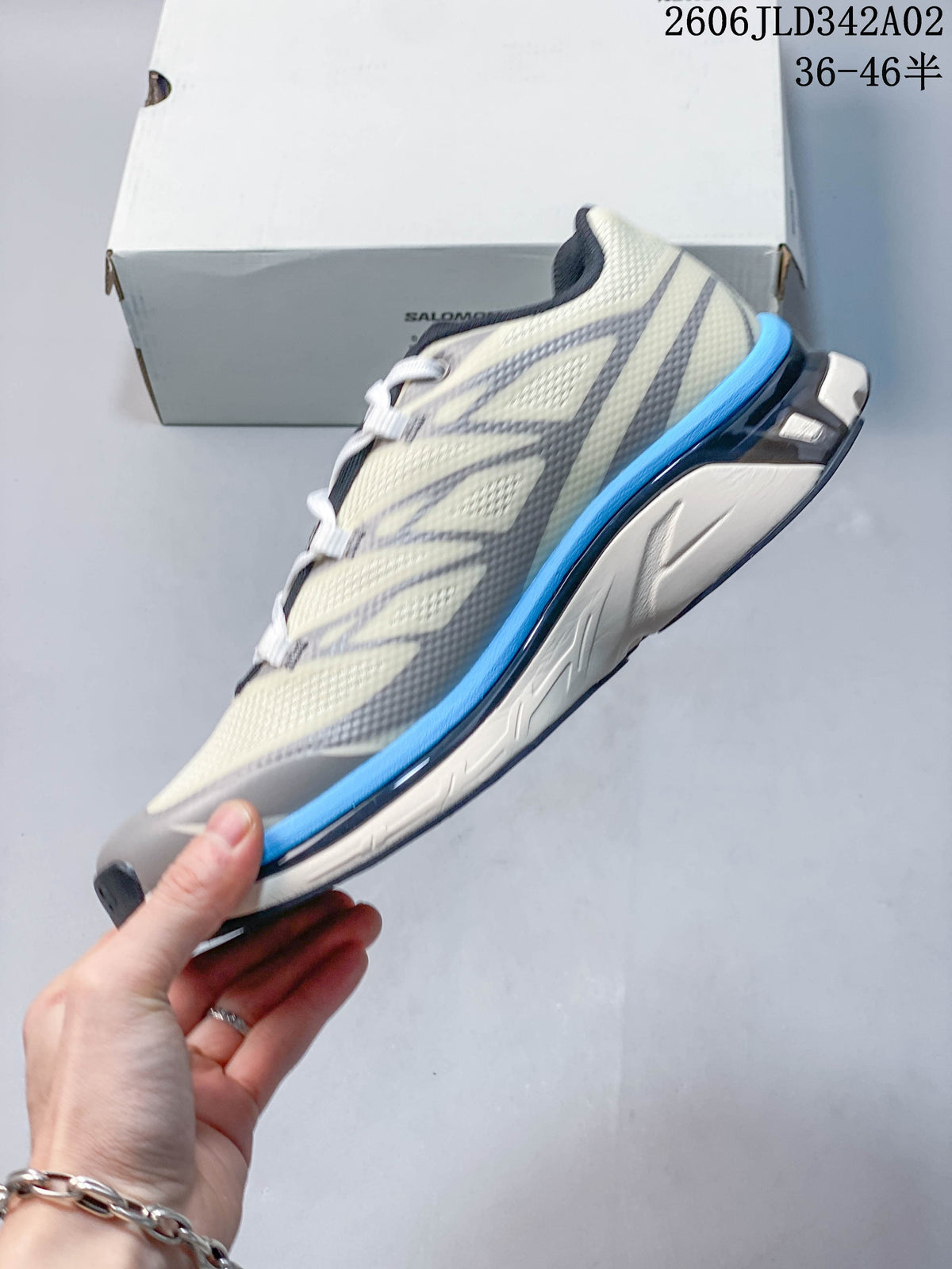 Side profile of the ivory, gray, and blue trail shoe