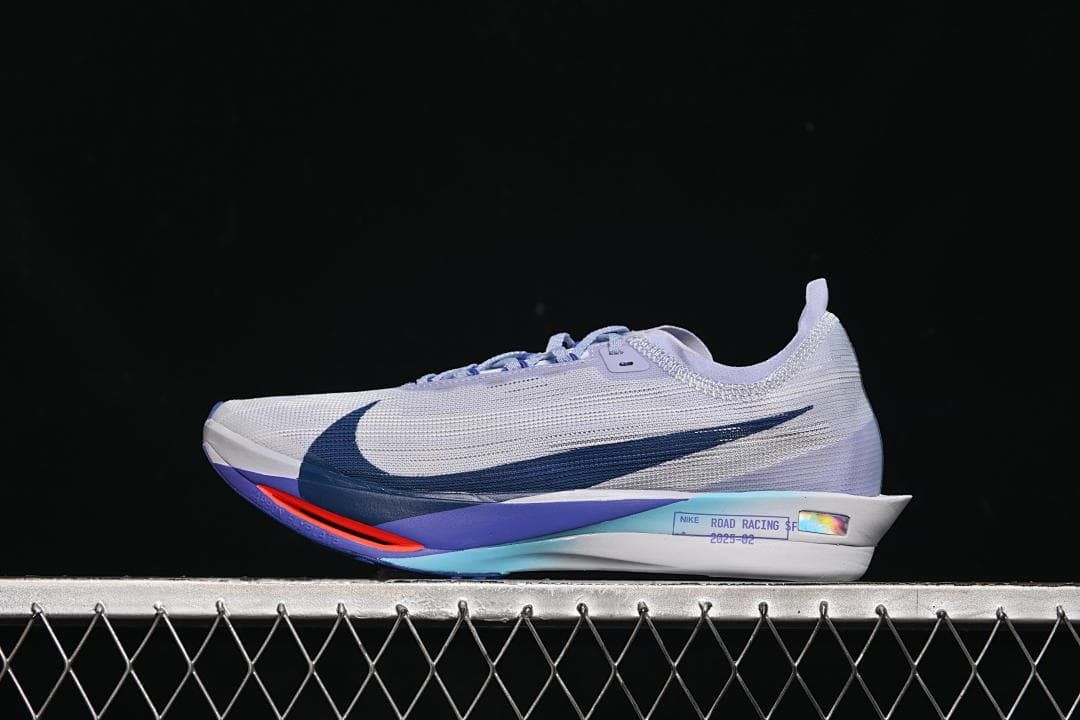 Side view of a light gray Nike ZoomX Streakfly 2 with dark blue swoosh and lavender and coral accents.