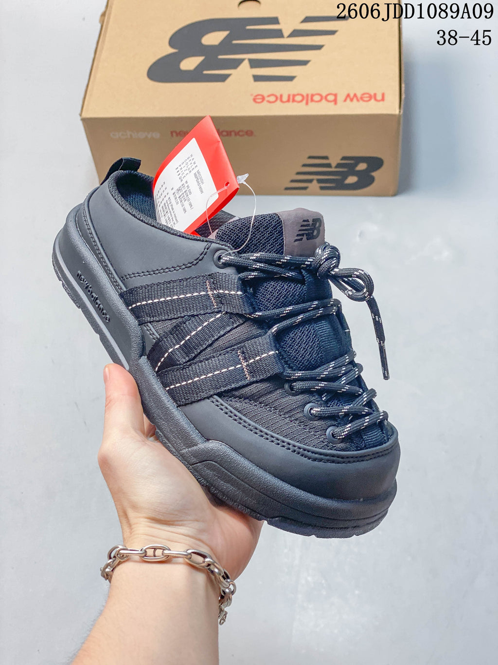 Close-up of a navy New Balance Terrace Mule with webbing straps and laces.