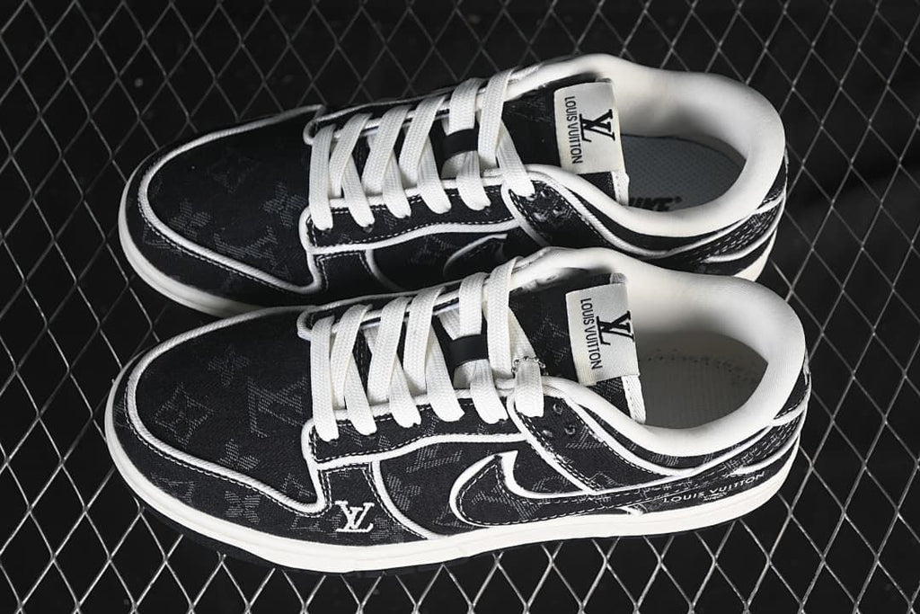 Top view of a pair of black patterned low-top sneakers with white laces and contrasting trim
