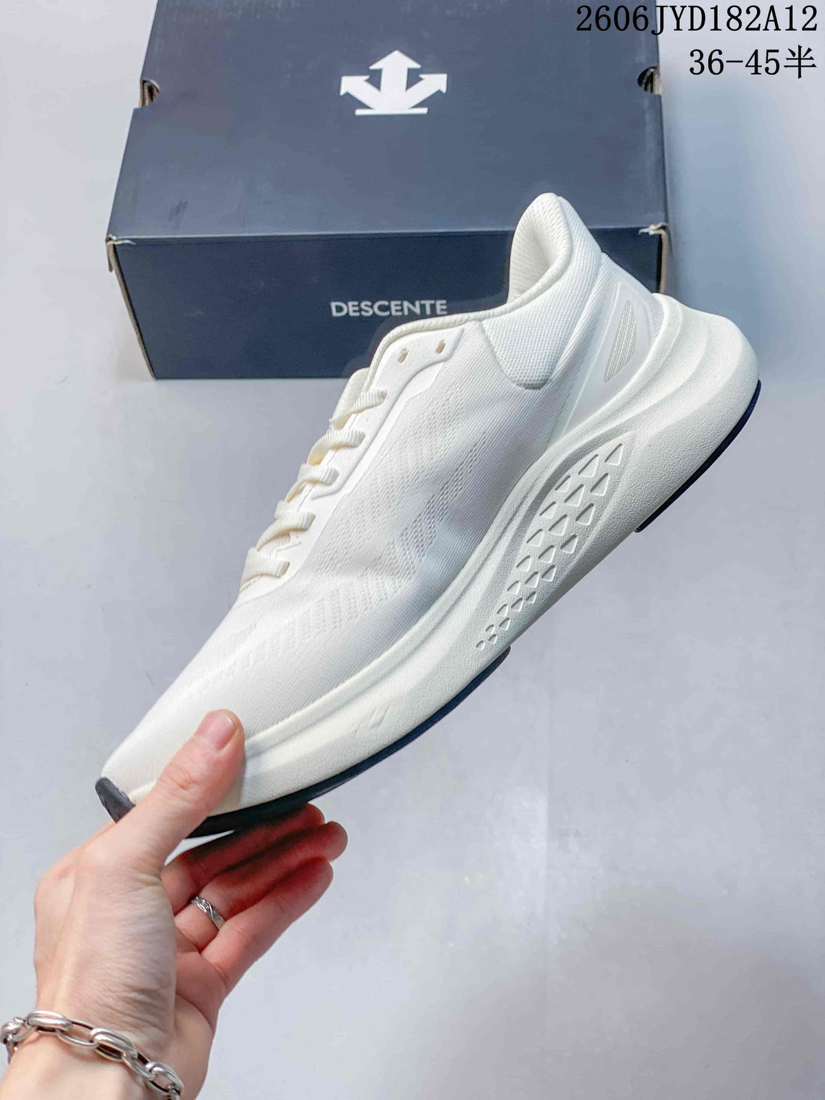 Side view of the white lace-up sneaker with textured upper and sculpted midsole.