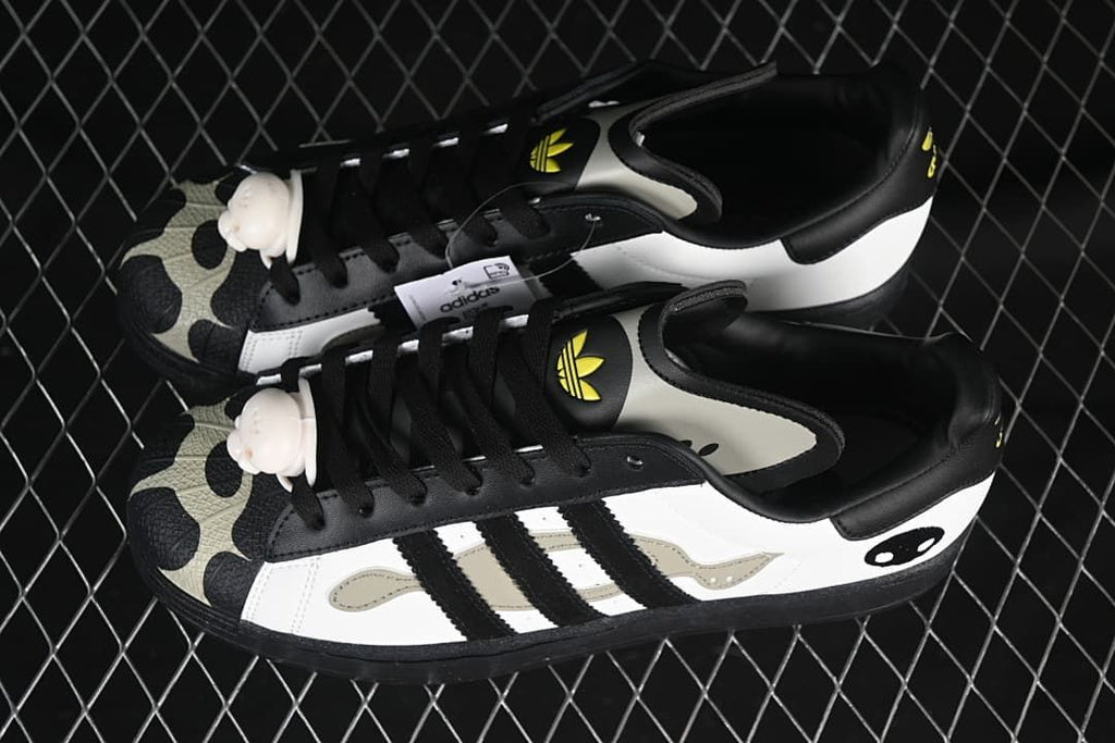 Pair of white and black Superstar 82 sneakers shown from above