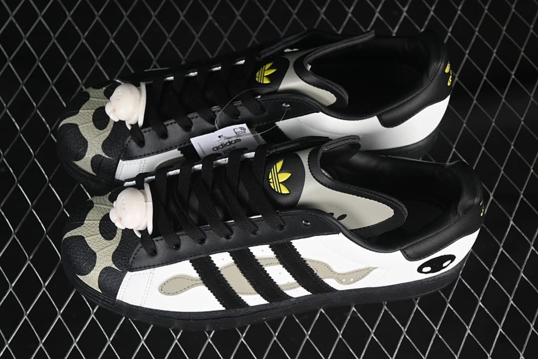 Pair of white and black Superstar 82 sneakers shown from above