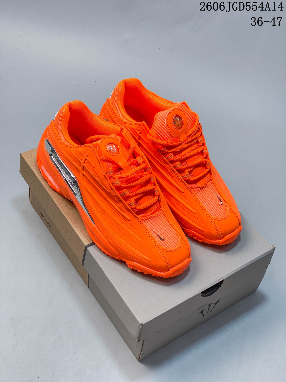 Pair of bright orange Nike NOCTA Hot Step 2 low-top sneakers on a box