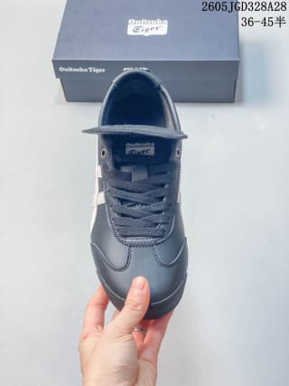 Top view of a navy Onitsuka Tiger sneaker showing its laces and fold-over tongue flap
