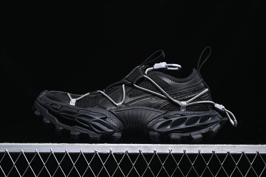 Black Hike Trail sneaker in side profile with cord lacing and a chunky lugged sole.