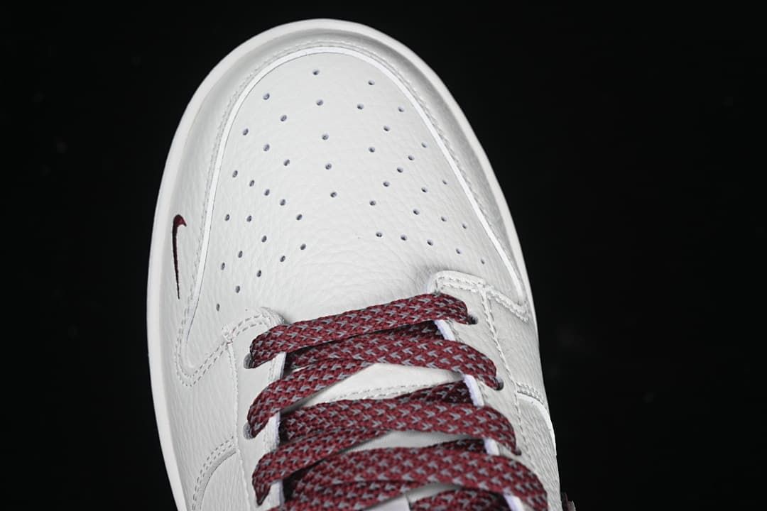 Top-down close-up of perforated toe and patterned burgundy laces