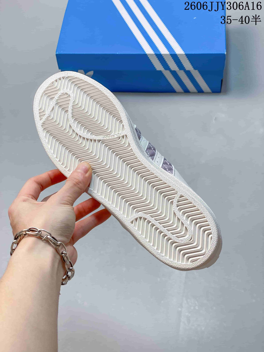 Underside of the sneaker showing its patterned rubber outsole