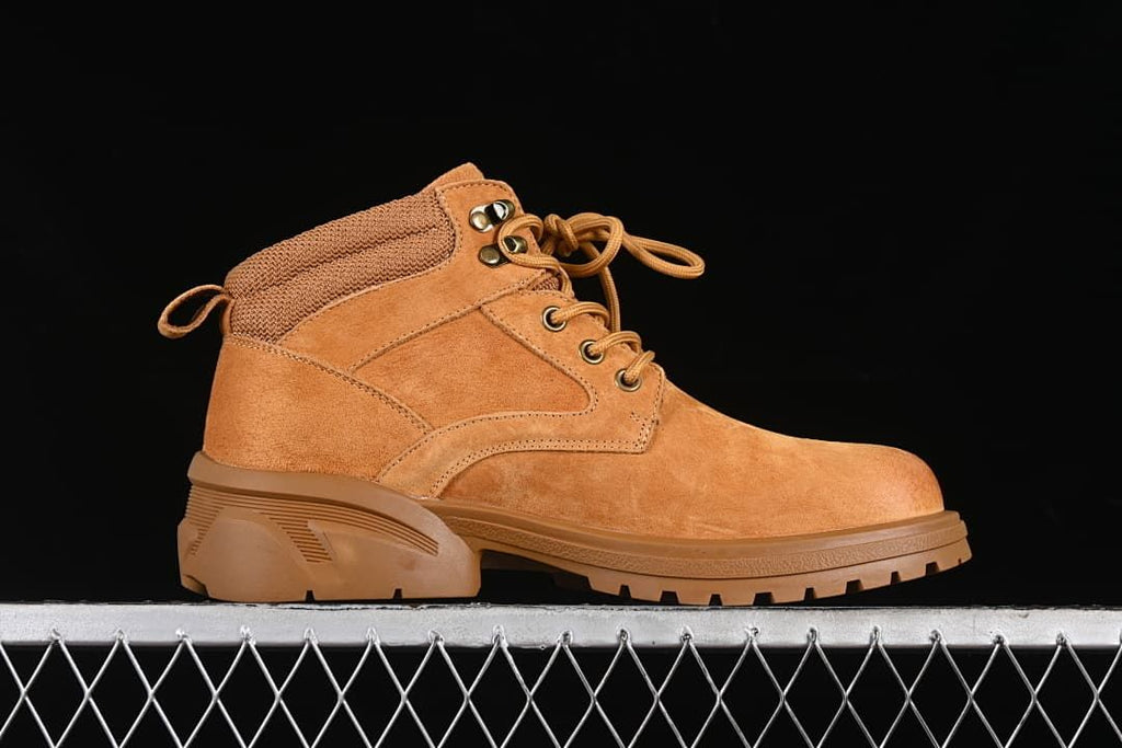 Side profile of a yellow-brown mid-top lace-up boot