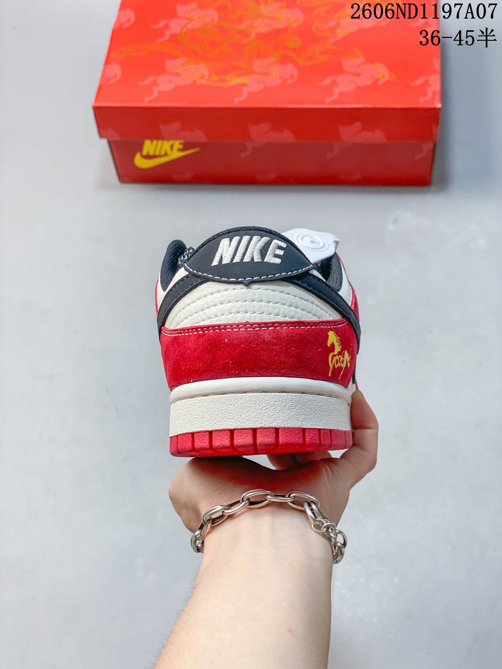 Rear view of the sneaker with a red heel panel and navy collar detail