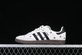 Side view of a white adidas Samba OG W with black stripes, purple flower embroidery, and dark brown outsole