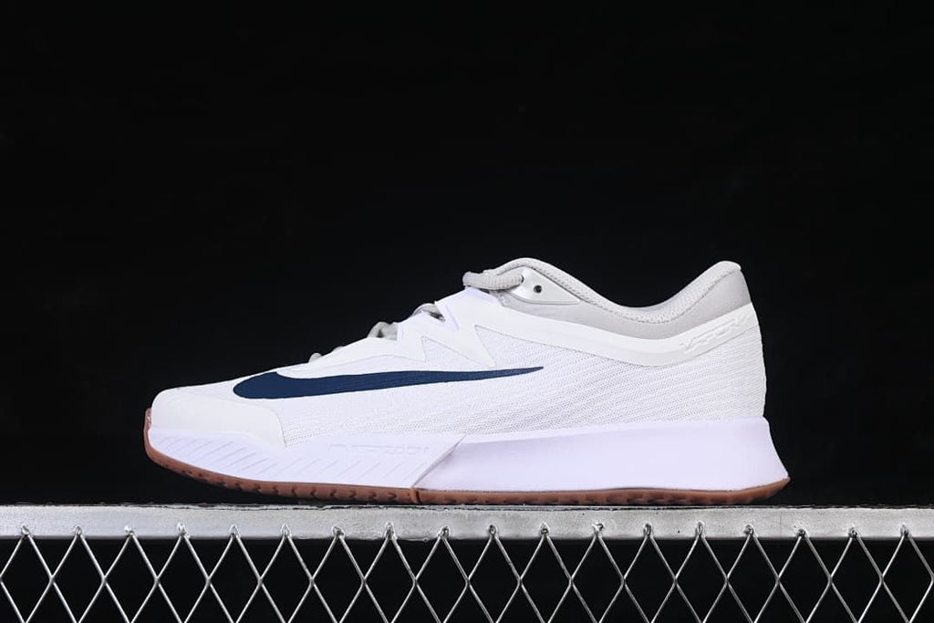 Side view of a white Nike Zoom Vapor Pro 3 shoe with navy Swoosh and gum-colored outsole.