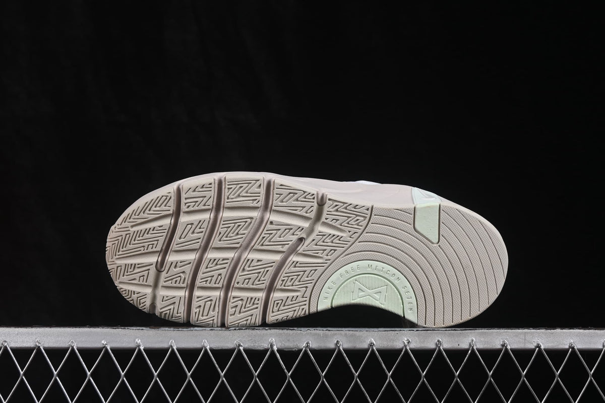 Bottom view of the sneaker showing the segmented outsole and geometric tread pattern.