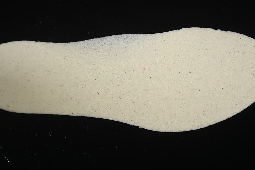 Light-colored shoe insole shown by itself