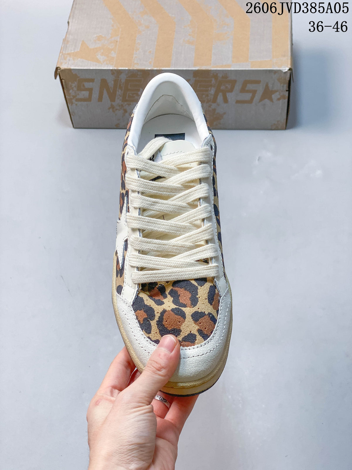 Top view of a leopard-print sneaker with cream laces and toe trim.