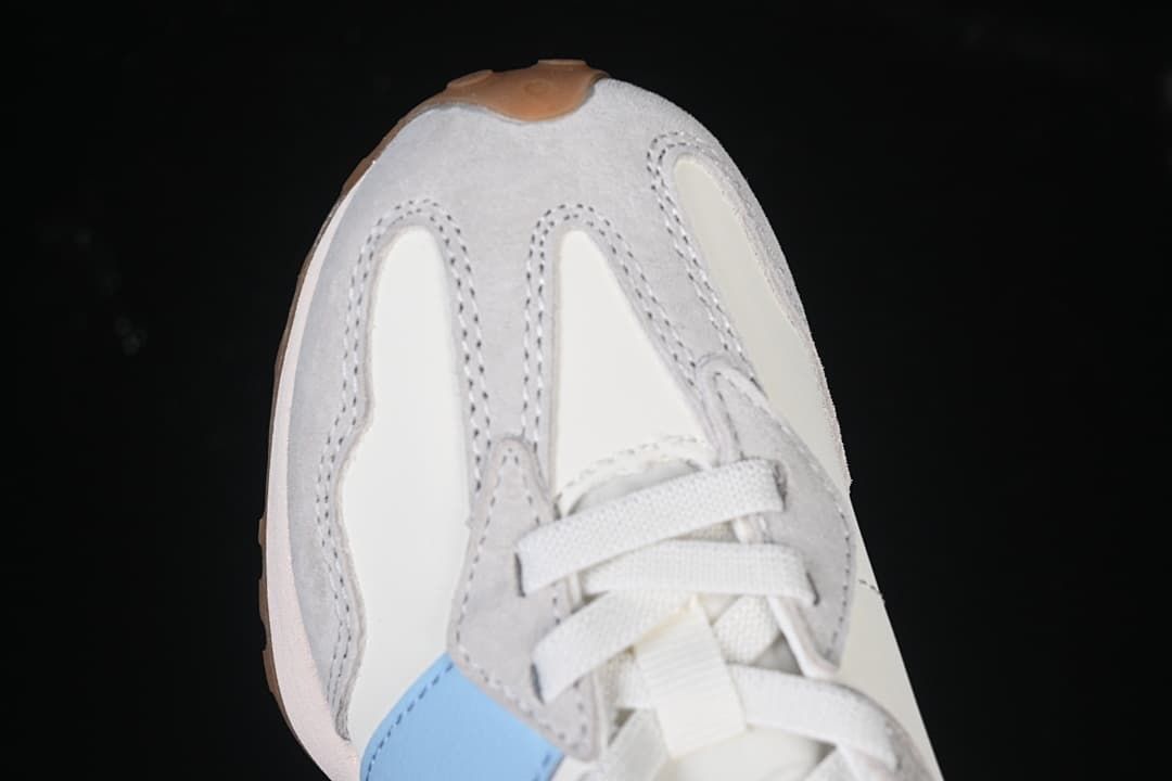 Close-up view of the sneaker toe, grey overlays, and laces.