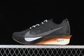 Side view of a dark Nike road racing shoe with light laces and copper-toned midsole accent.
