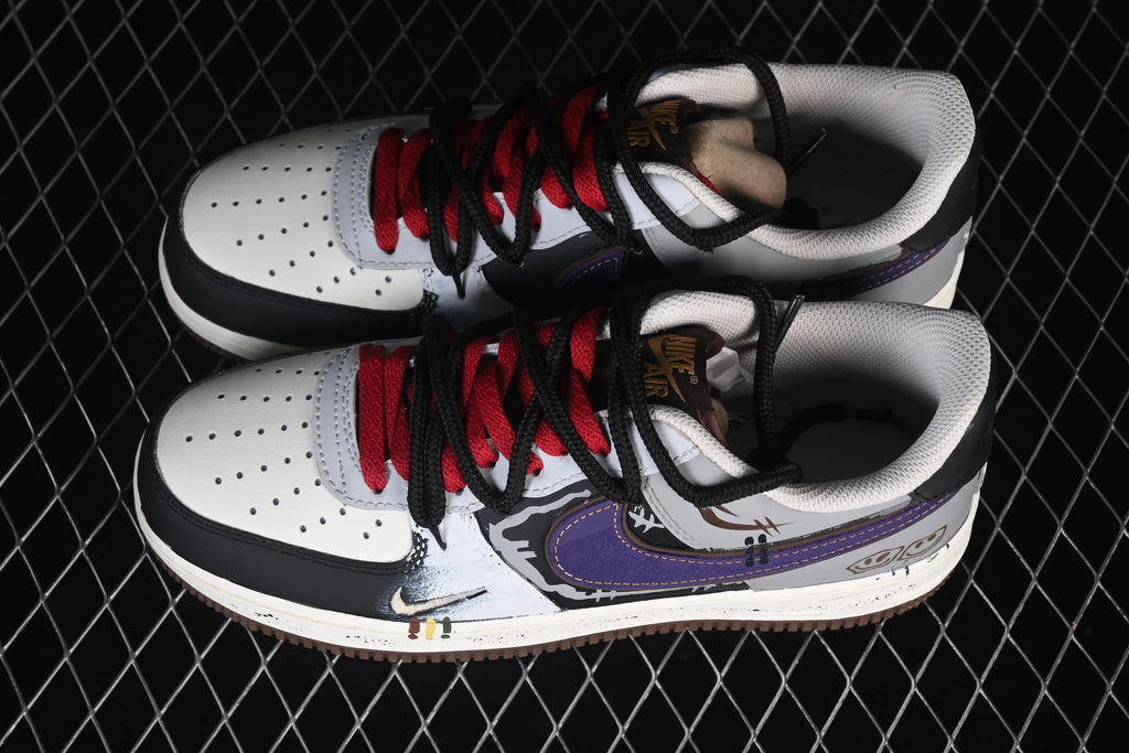 Pair of white, black, gray, and purple graffiti-style low-top sneakers with red and black laces