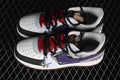 Pair of white, black, gray, and purple graffiti-style low-top sneakers with red and black laces