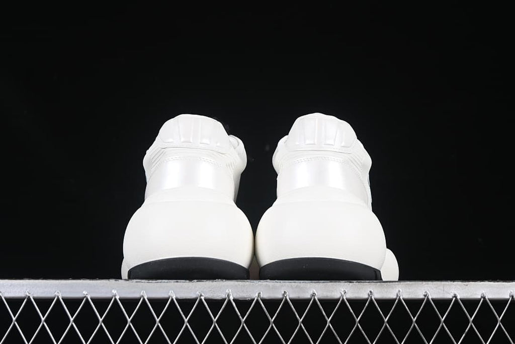 Rear view of the pair highlighting the heel panels and black outsole edges