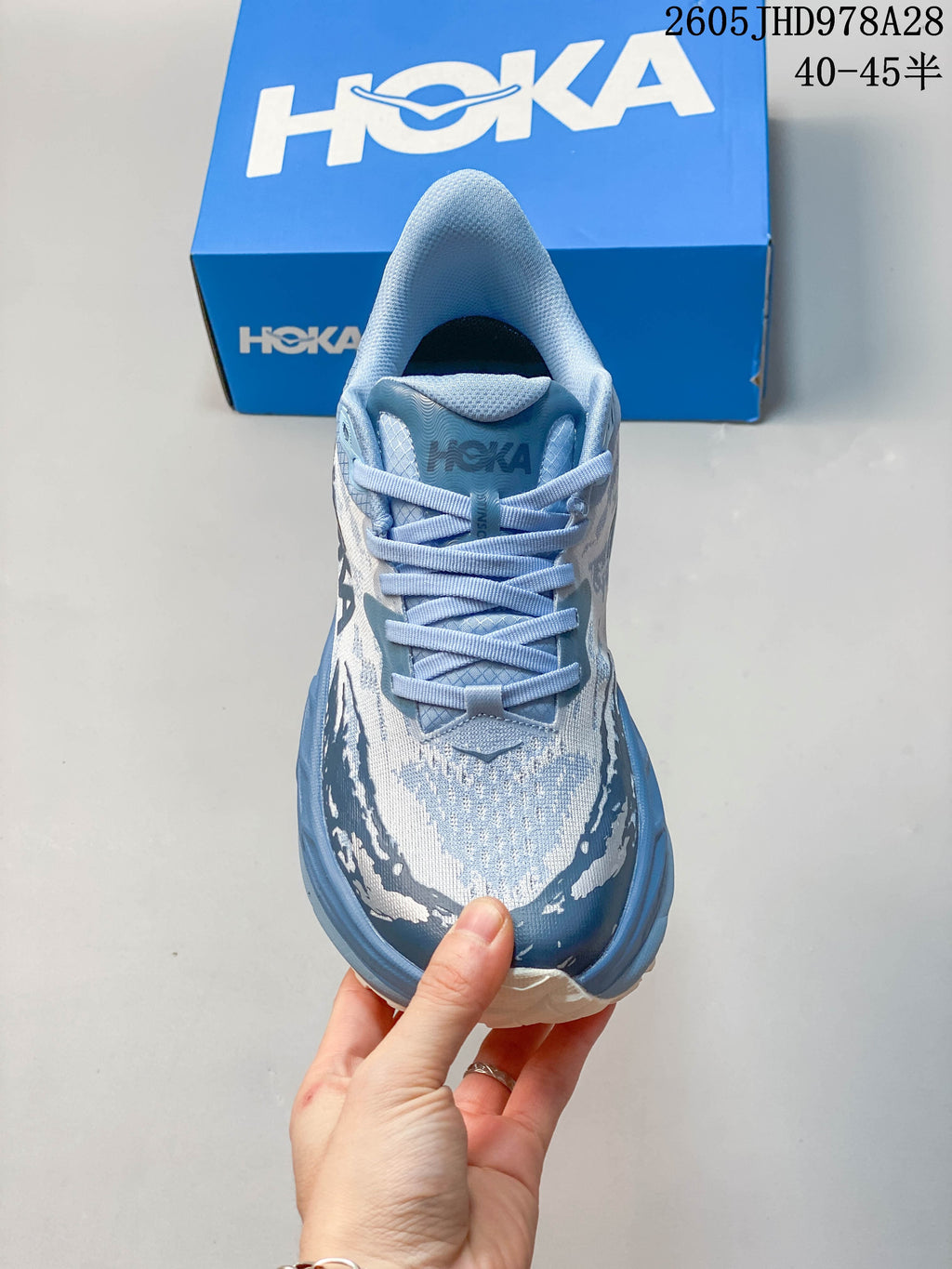 Top view of the lace-up HOKA Stinson 7 in a blue and white pattern