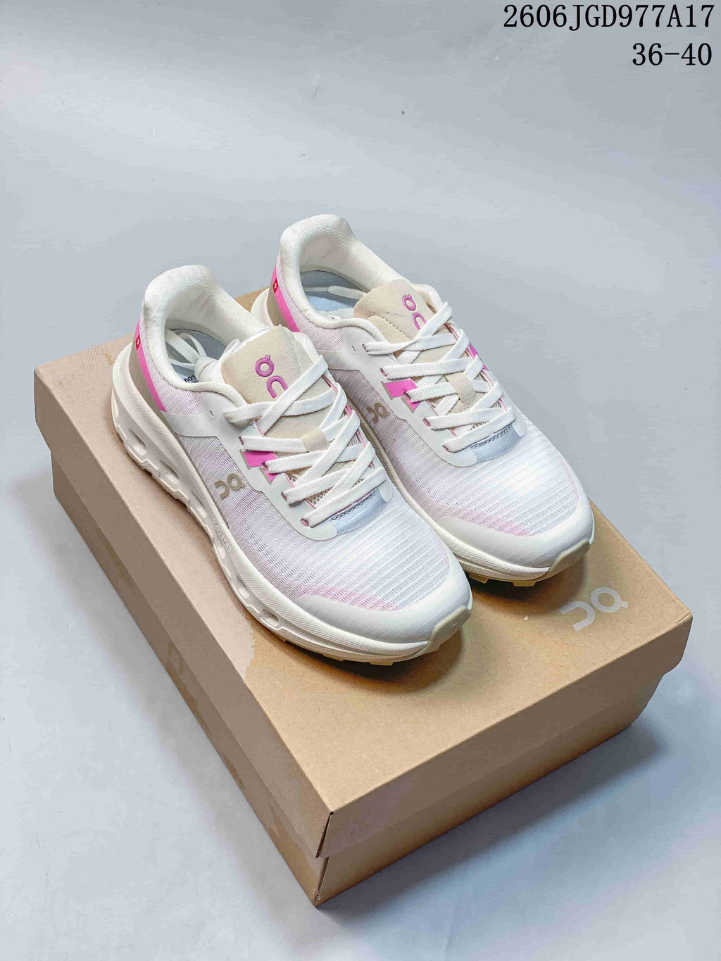 Pair of white and pink On Cloudvista 2 shoes displayed on a box.