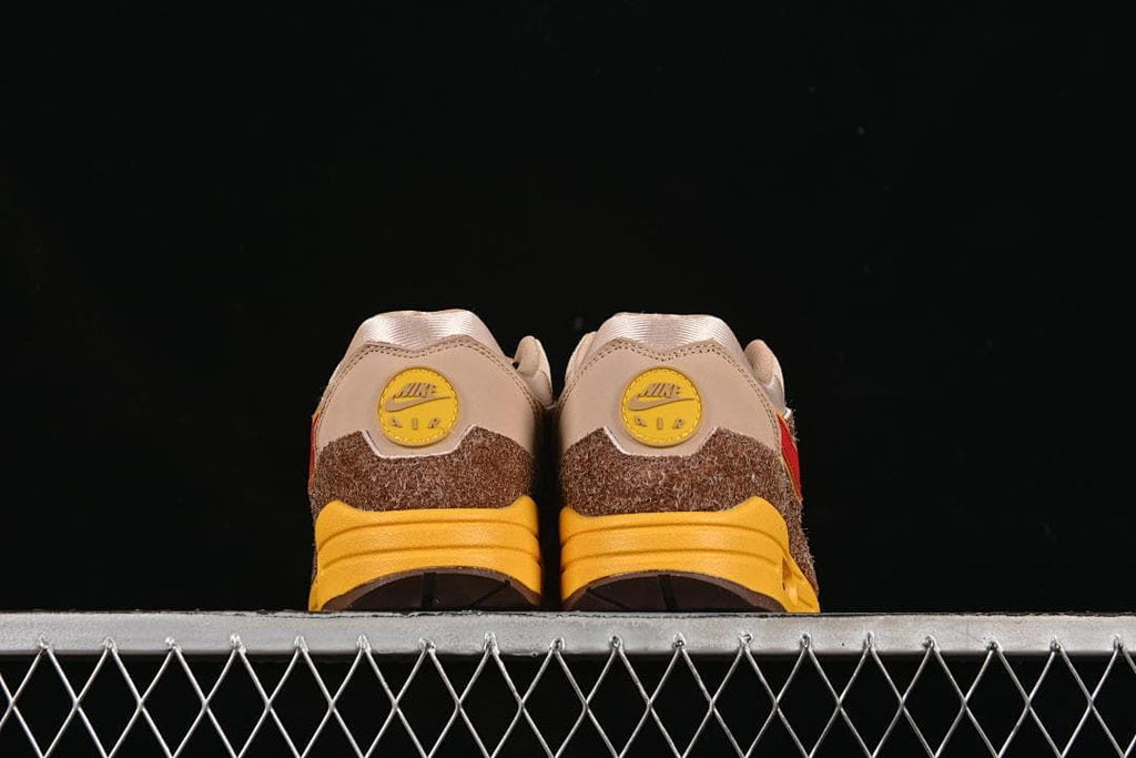 Rear view of the pair showing yellow heel badges and brown overlays.