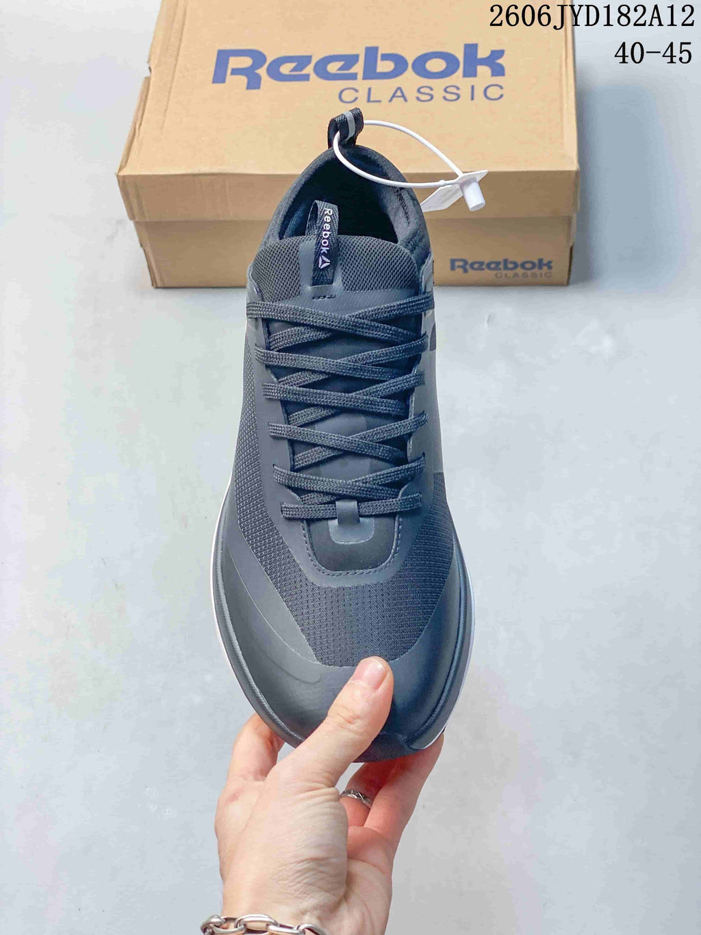 Top view of a dark gray lace-up Reebok sneaker