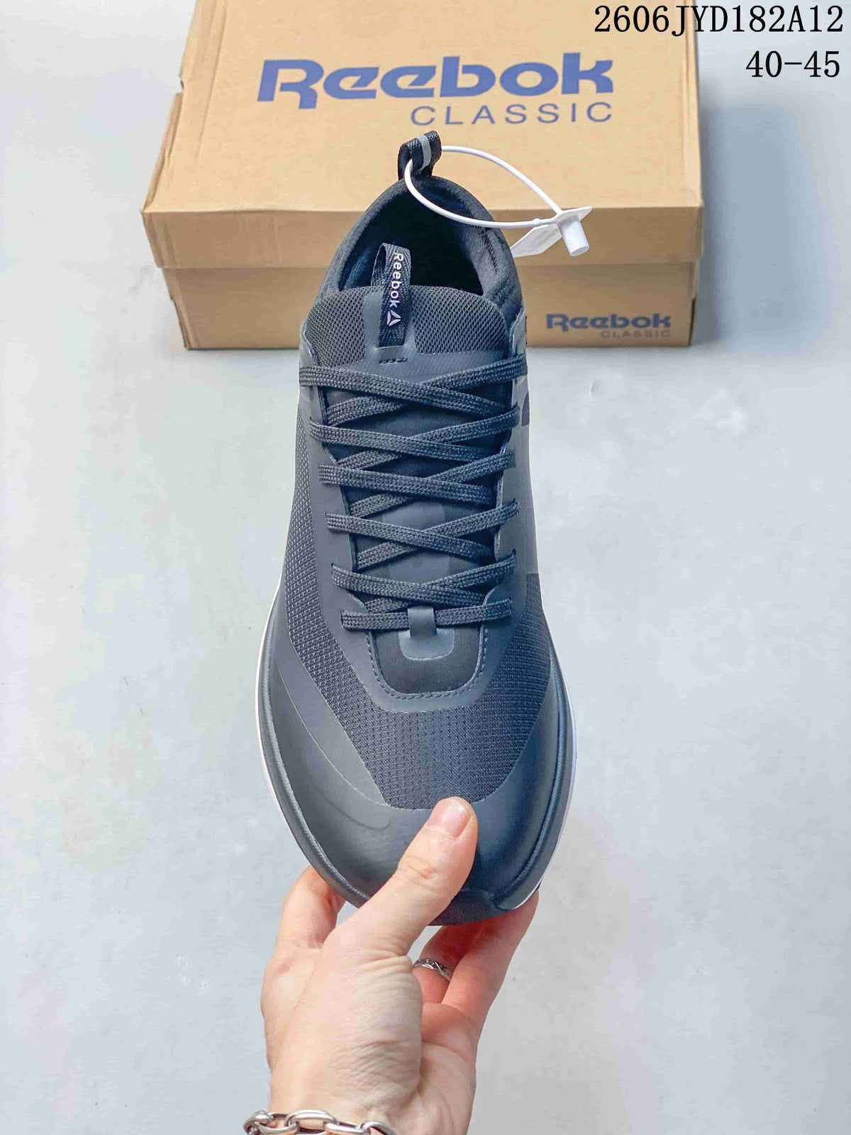 Top view of a dark gray lace-up Reebok sneaker