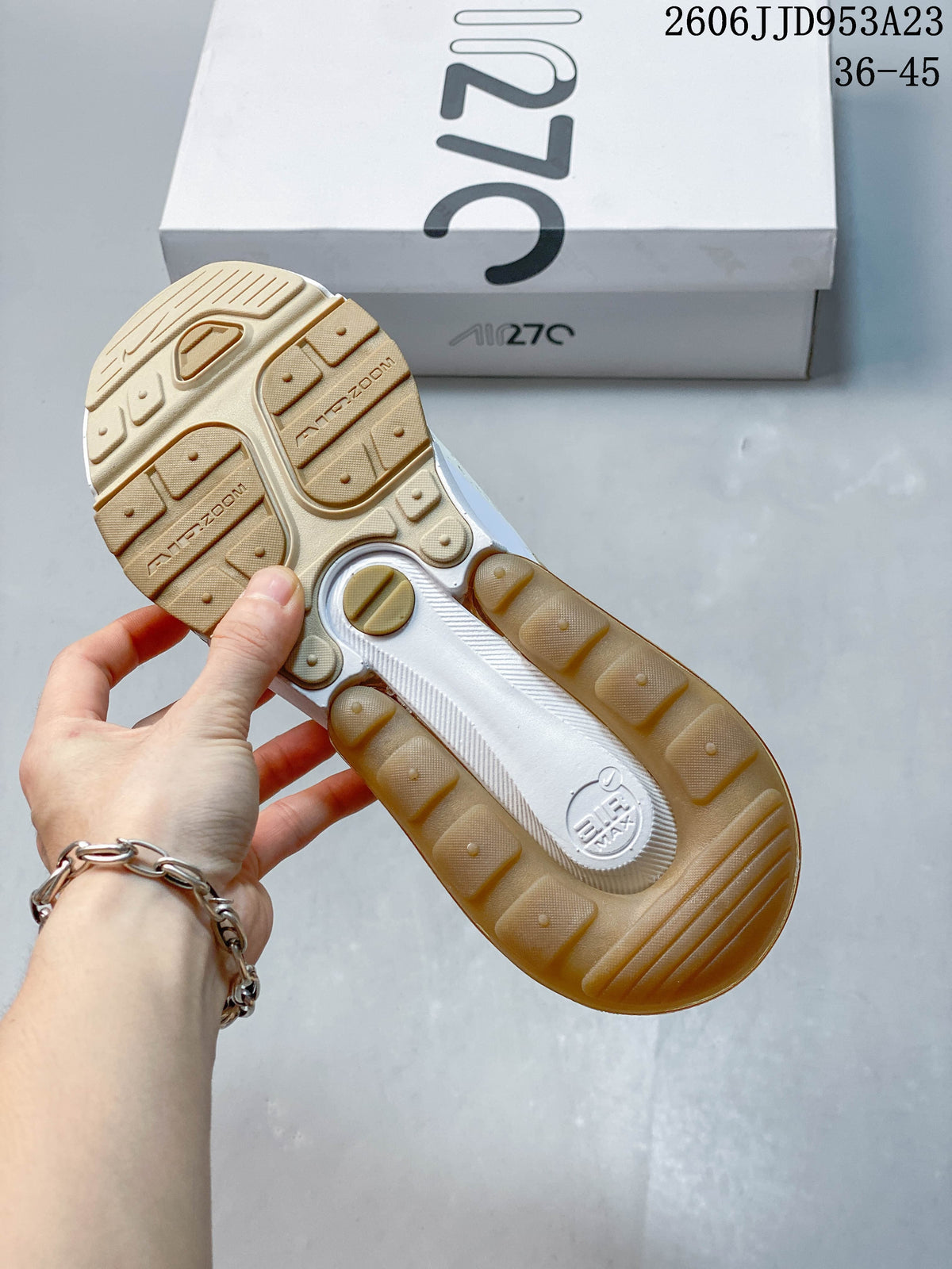 Outsole view of a Nike Air Max 270 sneaker with gold-tone tread