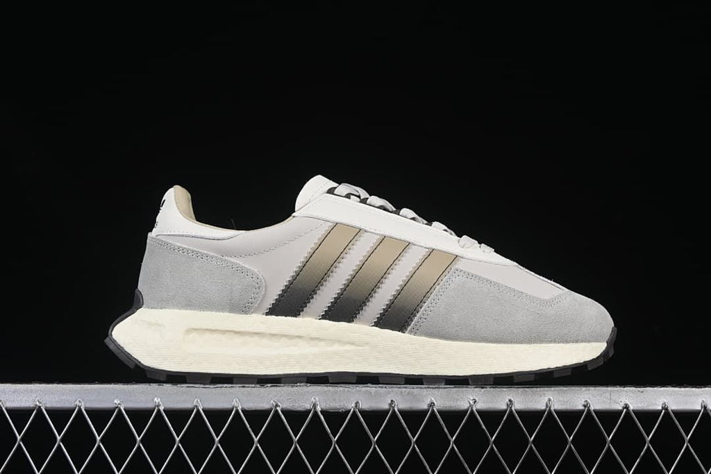 Side profile showing the layered upper, stripe detail, and cream-colored midsole