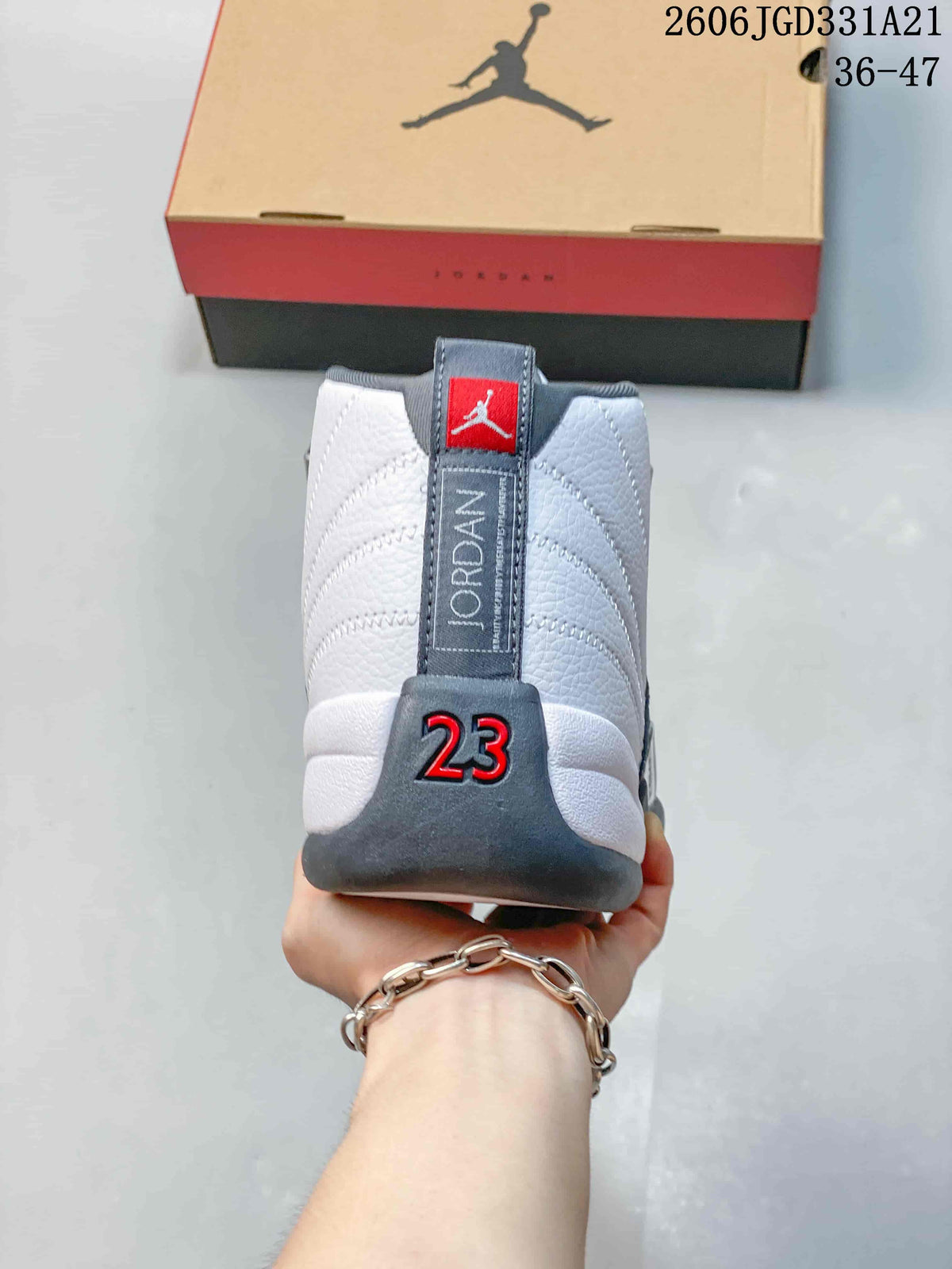 Rear view of a white and grey Air Jordan 12 shoe with a red 23 detail