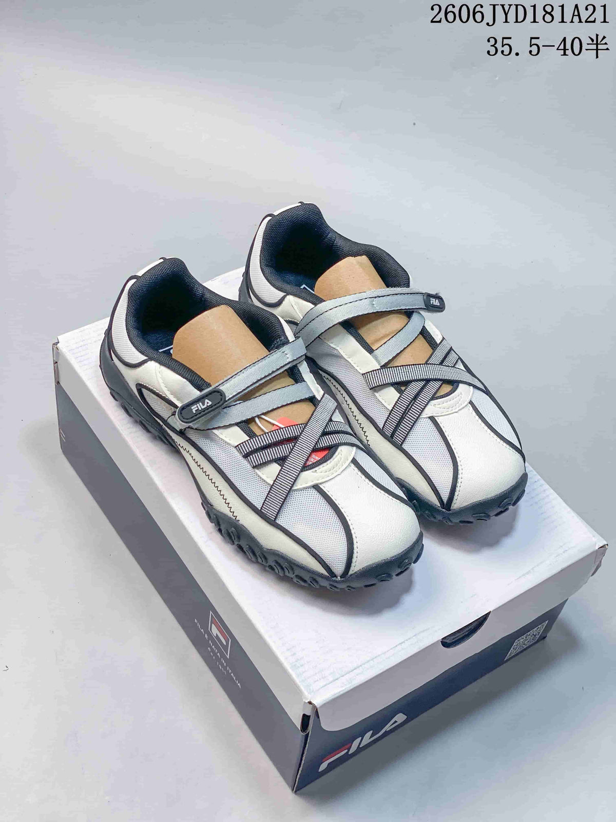 White and gray FILA Pebble Sandal shoes with dark accents and crossed straps
