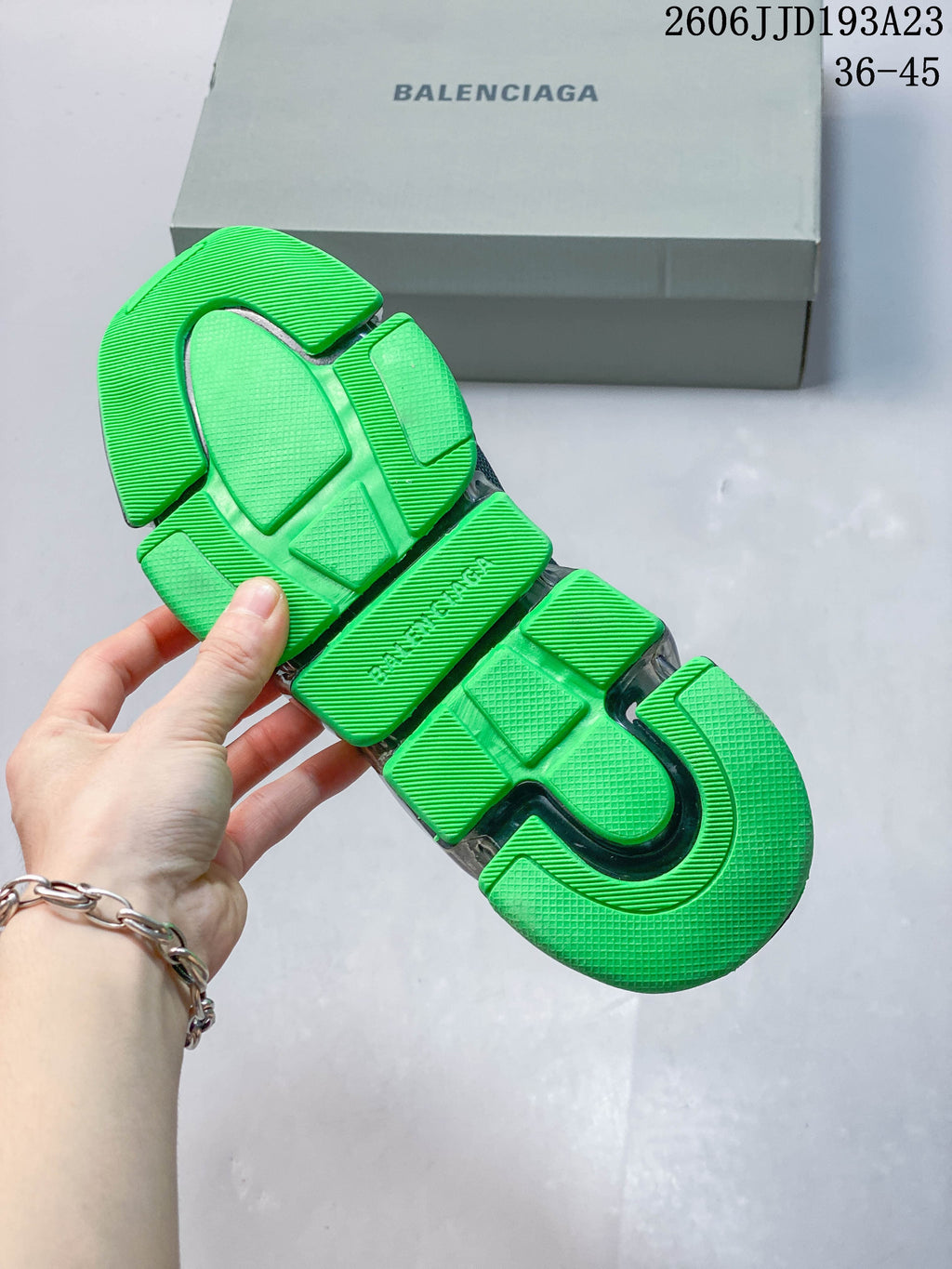 Close-up of the sneaker outsole showing textured neon-green sections