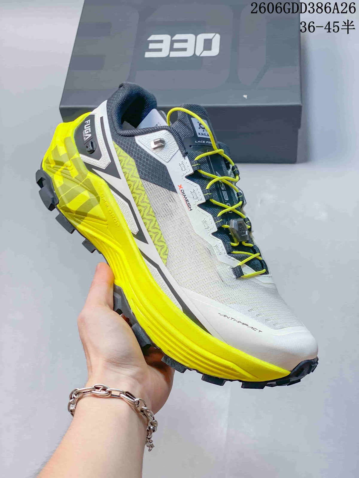 Side view of a white and gray KAILAS FUGA EX330 shoe with bright yellow outsole details