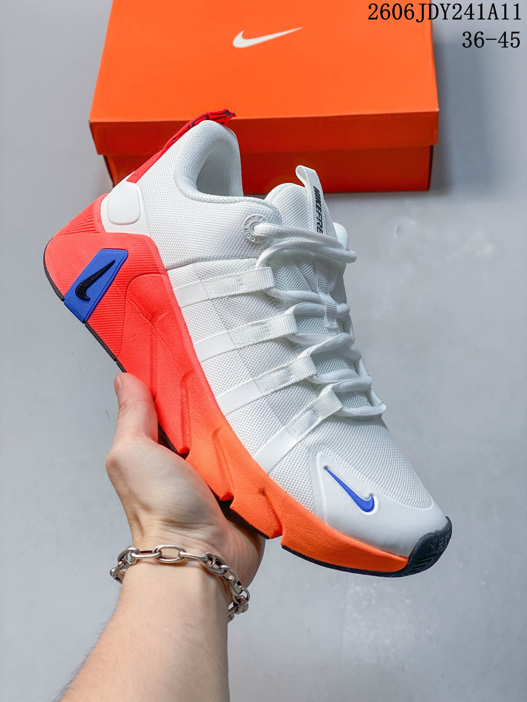 White Nike Free Metcon 7 training shoe with bright coral and blue accents.