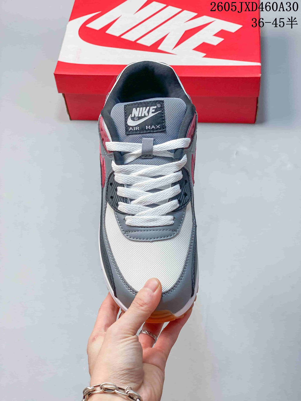 Top view of the Nike Air Max 90 showing its laces, tongue label, and color-blocked upper.
