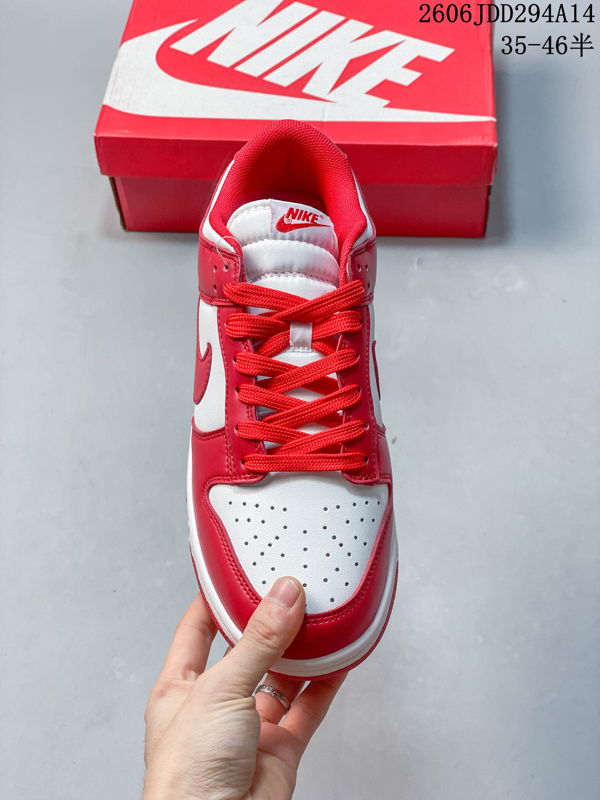 Top view of a red and white Nike Dunk Low sneaker showing the perforated toe and laces.