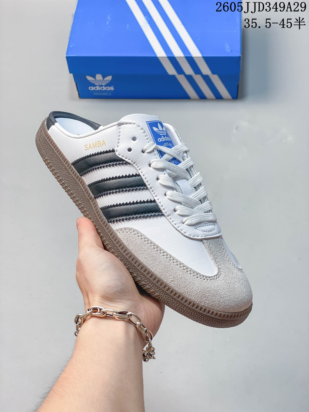 Angled side view of the mule sneaker with dark stripes, a light toe overlay, and gum-colored sole.