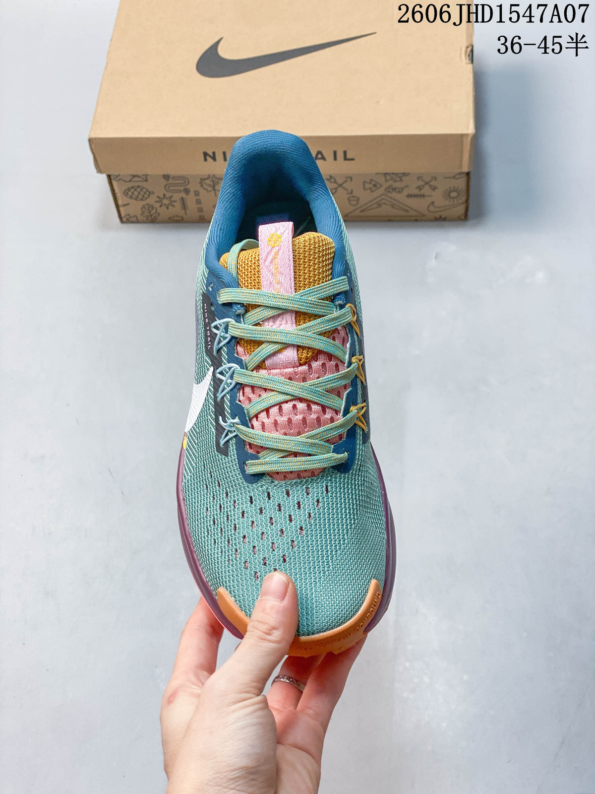 Top view showing the laces, tongue, and teal upper of the Nike ReactX Pegasus Trail 5.