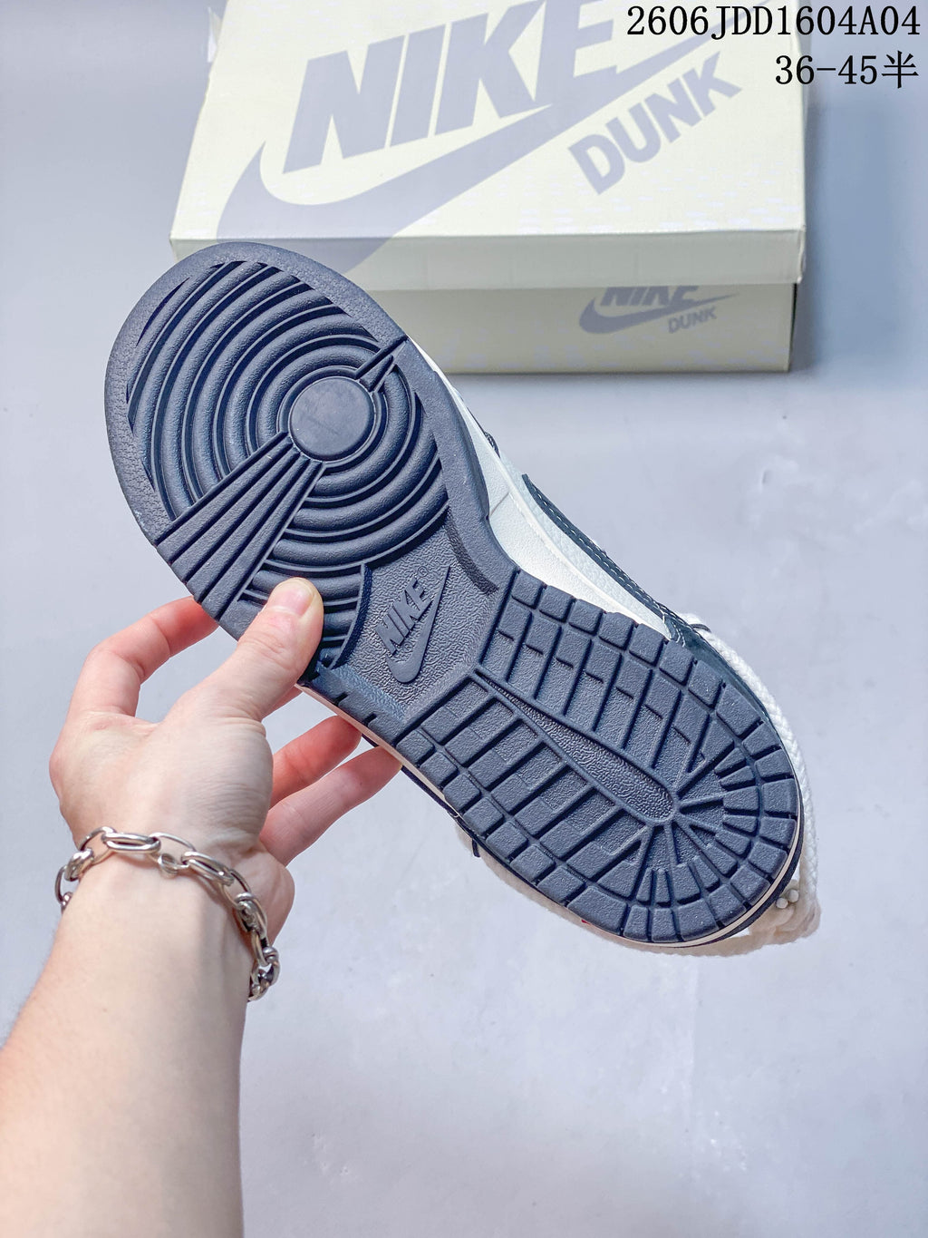 Close-up of the navy blue patterned outsole on a low-top sneaker.