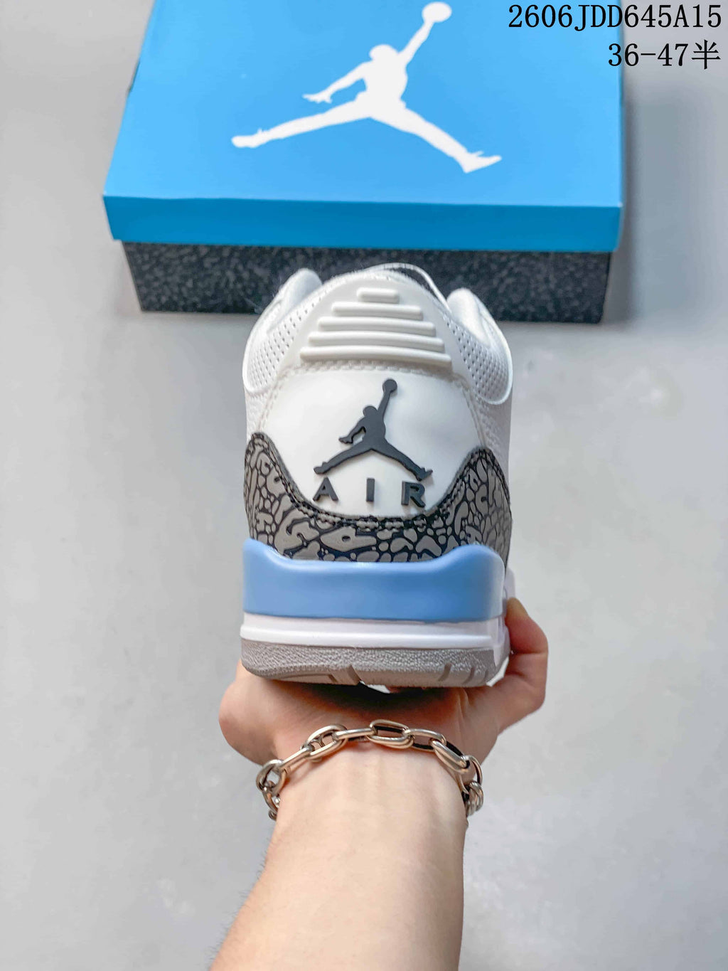 Rear view of the sneaker showing elephant-print heel panels and blue heel accent.