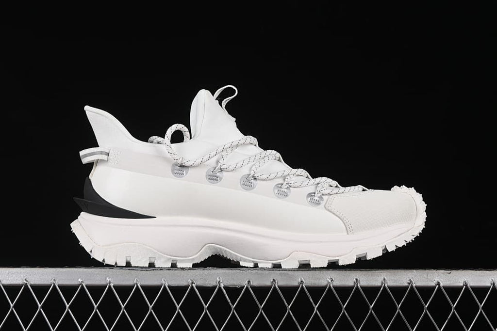 Side profile of a white sneaker with a thick rugged outsole