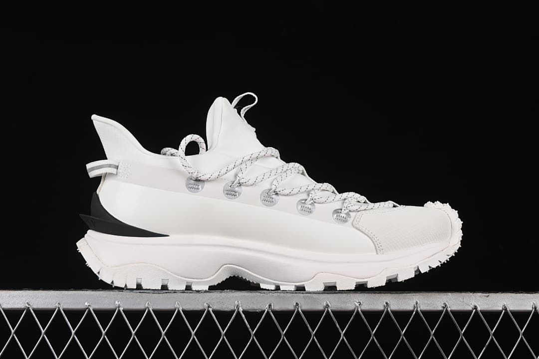 Side profile of a white sneaker with a thick rugged outsole
