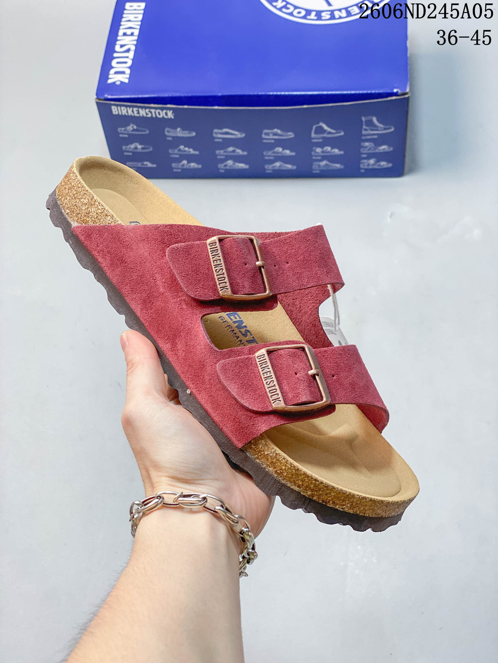 Red two-strap sandal with adjustable buckles.