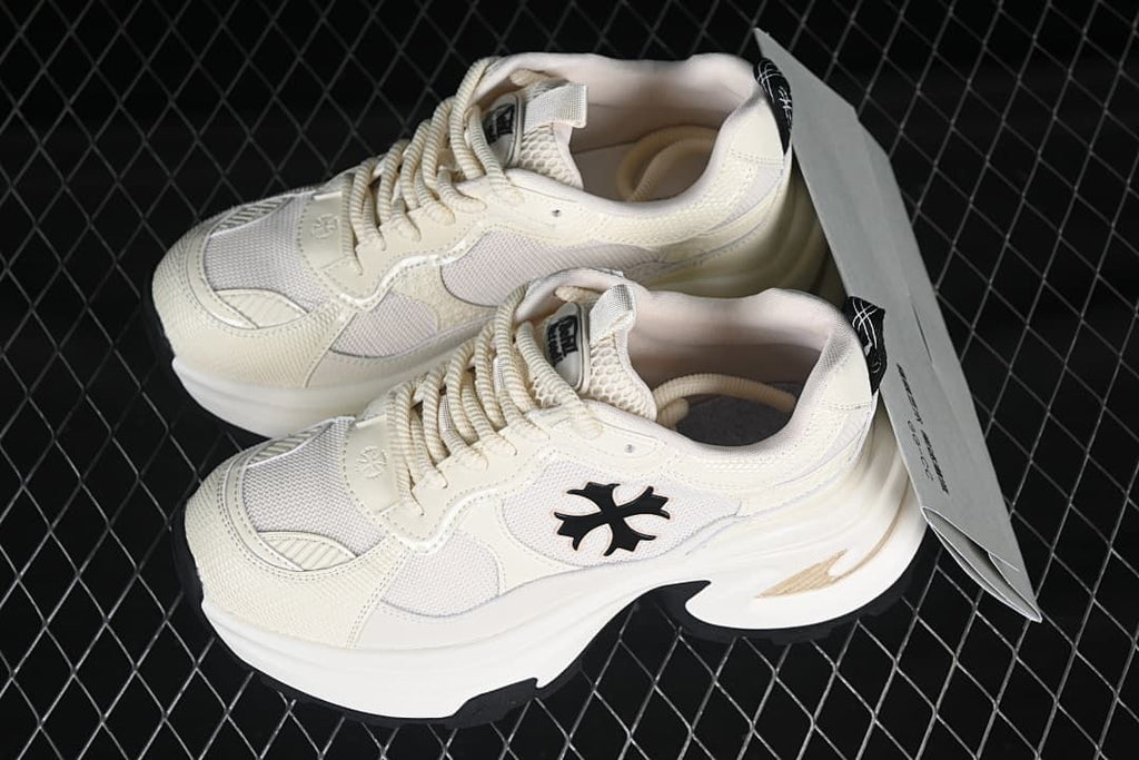 Pair of beige low-top sneakers shown at an angle